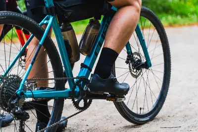 Close-up of a rider on a gravel bike on a gravel path