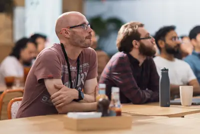 An audience listening at a conference talk